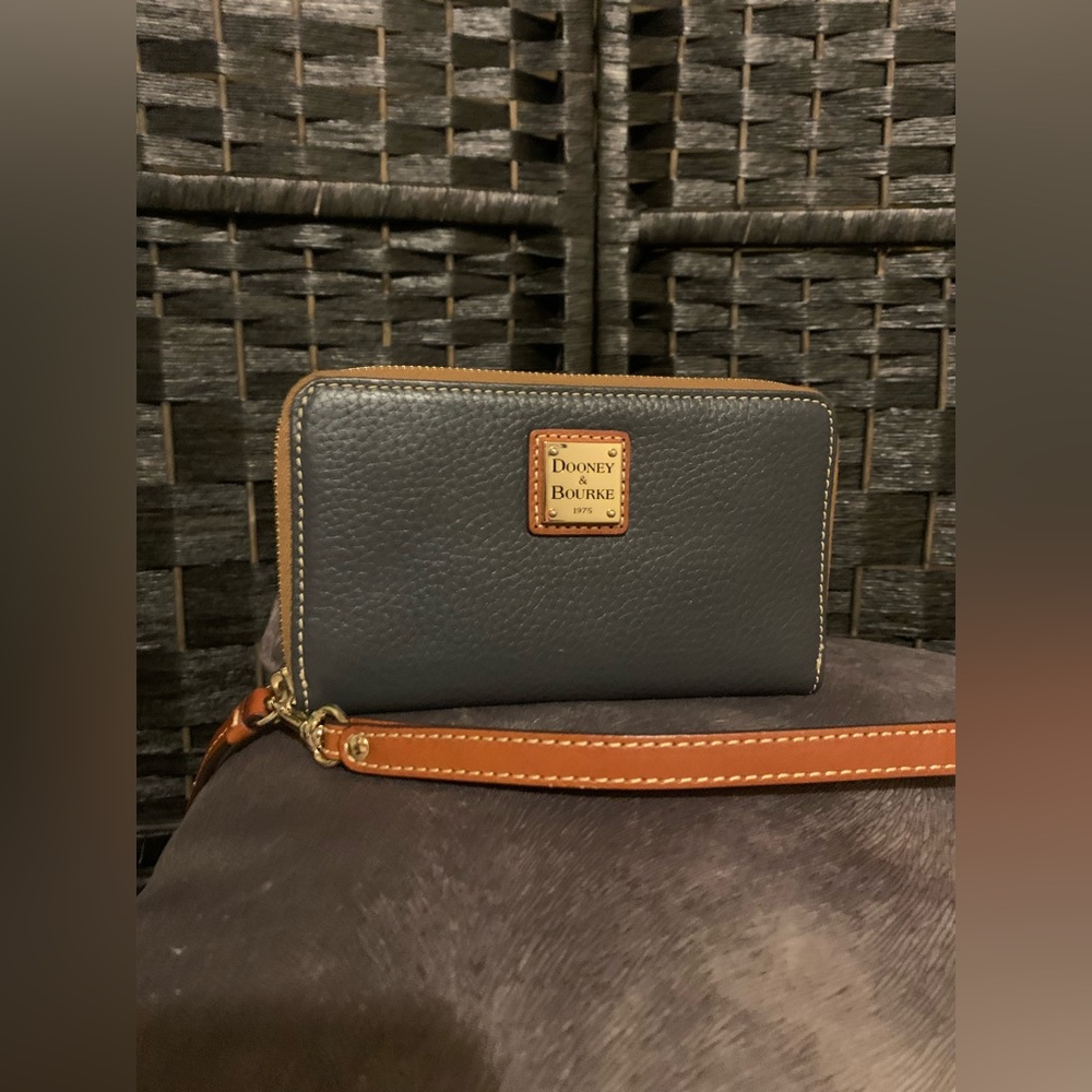 Dooney and bourke black with tan trim pebbled leather wallet/wristlet.
